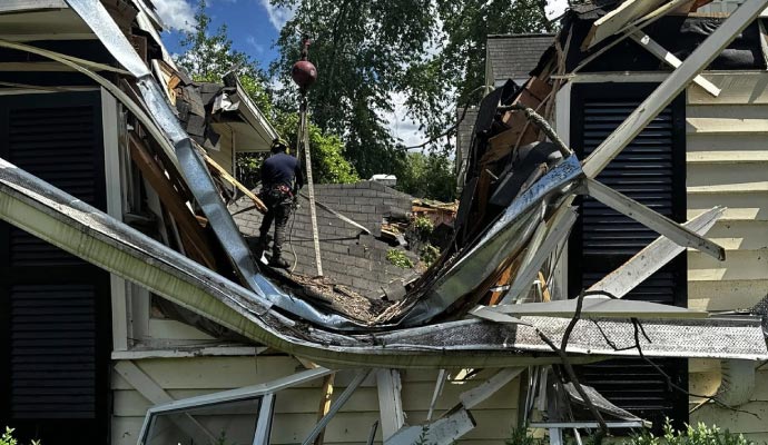 Professional worker restoring a storm damaged property