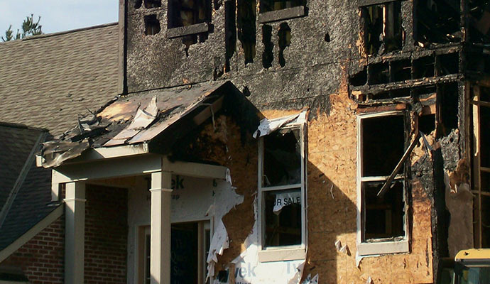 a front view of a house partially burned by fire