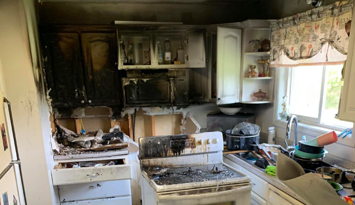 A burned kitchen with visible damage caused by fire