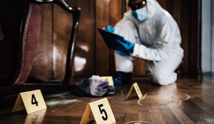 A person cleaning biohazard waste with equipment