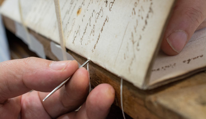 Person binding a book