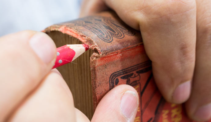 Person restoring an old book