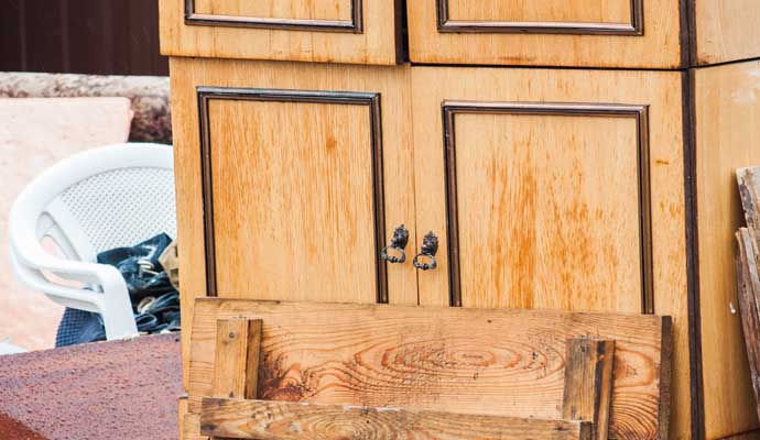 A wooden cabinet door with visible dmaged