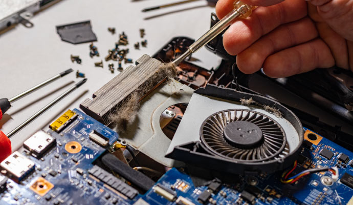 Person cleaning electronics device with equipment