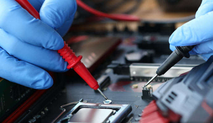 Person repairing an electronic device with equipment