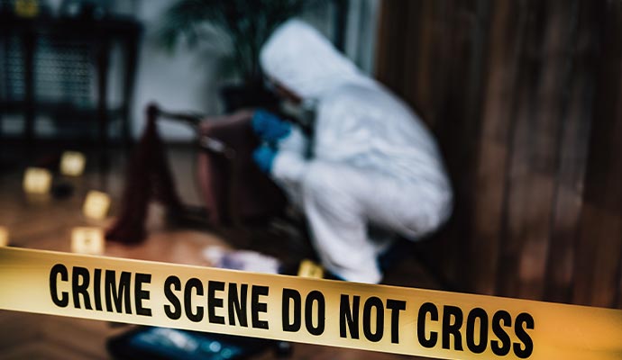 A person cleaning biohazard waste in a restricted area