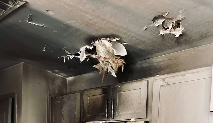 A kitchen ceiling with severe damage