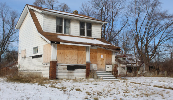 Boarded up storm damaged house