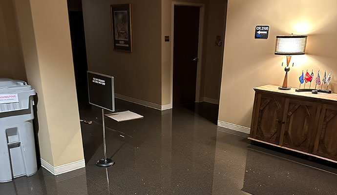 a hallway of a building flooded with water