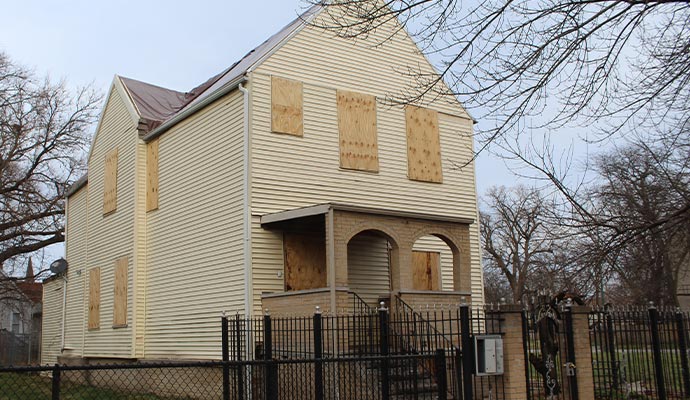 house with boarded doors and windows