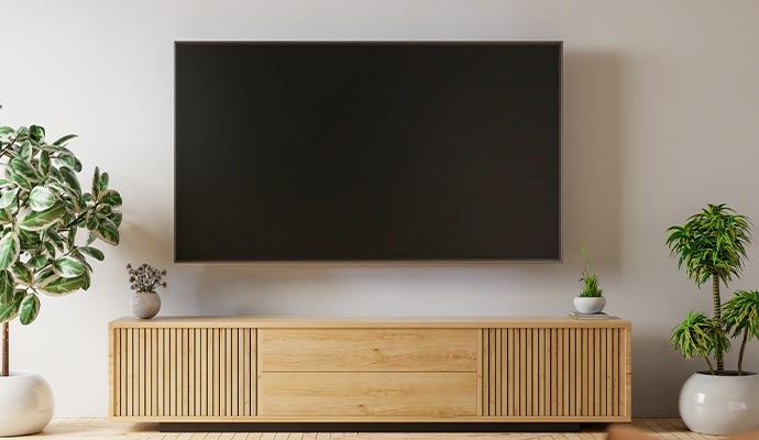 Wall-mounted TV in a modern living room Wall-mounted flat-screen TV in a modern living room