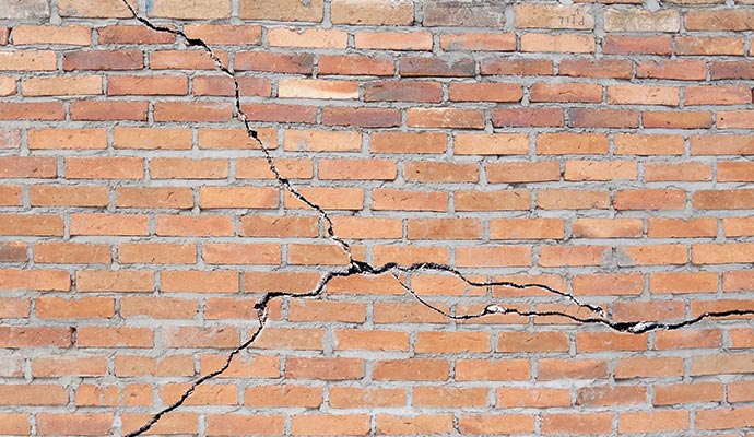 a brick wall with a crack running across